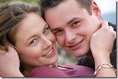 young couple kissing in the gras 7