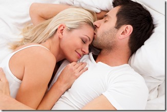Loving couple lying in bed